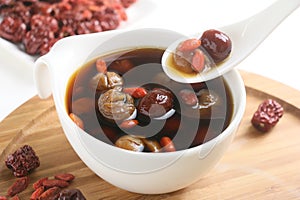 Wolfberry jujube tea longan in tea cup on wooden tray photo