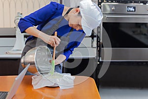 Woma pouring the finished cake into the mold.