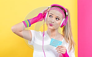 Woman in 1980`s fashion holding a cassette tape