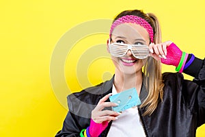 Woman in 1980`s fashion holding a cassette tape