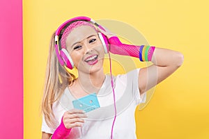 Woman in 1980`s fashion holding a cassette tape