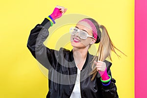 Woman in 1980`s fashion with shatter shade glasses