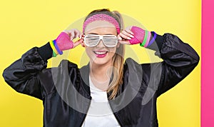 Woman in 1980`s fashion with shatter shade glasses
