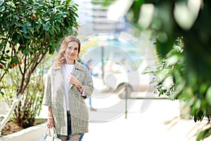 A woman 30-35 years old walks in the early autumn in the European Park while on vacation