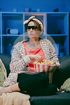 Woman in 3d glasses eating popcorn. Fun young woman in 3d glasses watching movie film, eat popcorn. People sincere