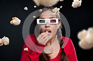 Woman, 3d glasses and horror with popcorn for eating, watching movie or shocked by dark background. Fantasy, face or