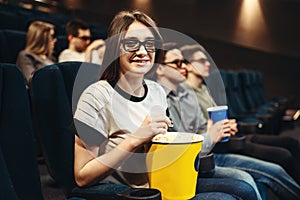 Woman in 3d glasses sitting on seat in cinema