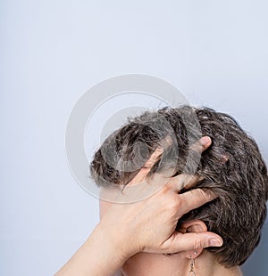Woman of 40-50 turned half face showing naturally gray hair. Natural ageing and diversity concept