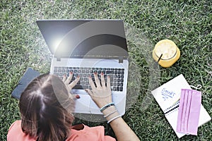 Woman 40 years old working outdoors with laptop while making healthy breakfast - Female entrepreneur or influencer lying down on