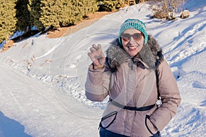 Woman 50 years old hiking in the mountains in winter, Almaty, Kazakhstan