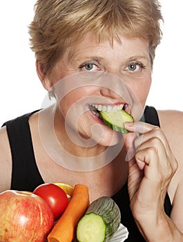 Woman (67 years old) eating vegetables