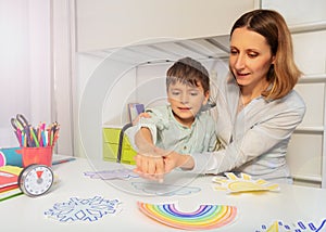 Woman during ABA therapy teach boy weather cards photo