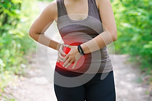 Woman with abdominal pain, injury while running, trauma during workout