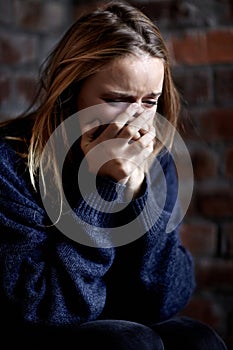Woman, abuse and crying with hands, scared and alone with fear, hiding and afraid. Toxic relationship, shame or home for