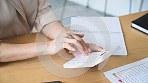 Woman accountant calculate business data at office desk.