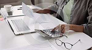 Woman accountant using calculator and computer in office panoramic banner, finance and accounting concept