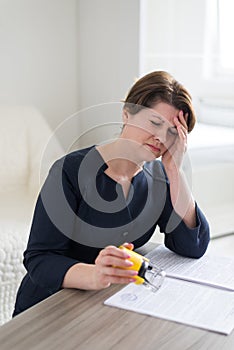 Woman accountant working with headache