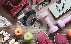 Woman active healthy lifestyle concept. Creative flat lay of sport and fitness equipments with woman accessories, apples, bottle