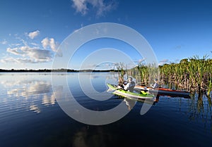 Woman and active senior kayaking on Nine Mile Pond in Everglades National Park.