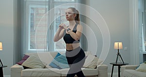 Woman in activewear doing fitness exercises. Females aerobics sport fit at home slow motion. Workout, training, wellness