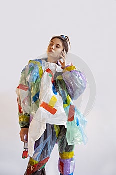 Woman addicted of sales and clothes, wearing plastic, recycling concept