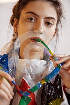 Woman addicted of sales and clothes, wearing plastic, recycling concept