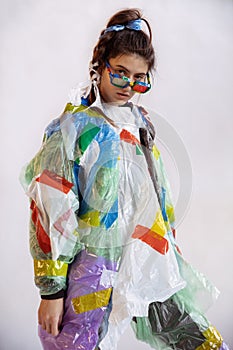 Woman addicted of sales and clothes, wearing plastic, recycling concept