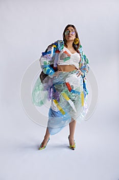 Woman addicted of sales and clothes, wearing plastic, recycling concept