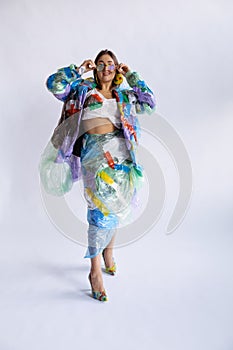 Woman addicted of sales and clothes, wearing plastic, recycling concept