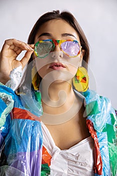 Woman addicted of sales and clothes, wearing plastic, recycling concept