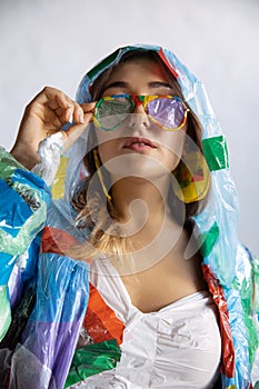 Woman addicted of sales and clothes, wearing plastic, recycling concept