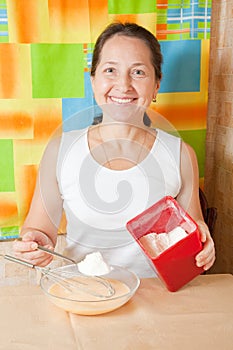 Woman adds flour into dish