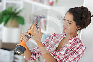 woman adjusting cordless drill