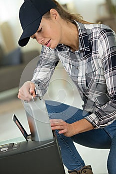 Woman adjusting oil on thermostat