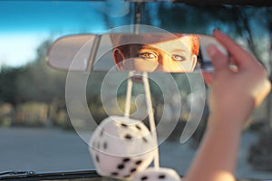 Woman Adjusting Rear View Mirror