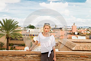 Woman admiring traditional moroccan architecture in one of the palaces in medina of Marrakesh, Morocco.