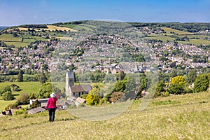 Woman admiring view across to Stroud from Selsley Common, The Cotswolds, Gloucestershire, England