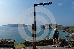 Woman admiring the view of Blasket Islands and Dunmore Head from Slea Head in Dingle Peninsula