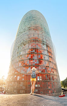 Woman admiring view of a famous Agbar tower in Barcelona