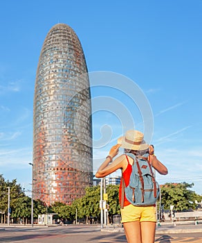 Woman admiring view of a famous Agbar tower in Barcelona