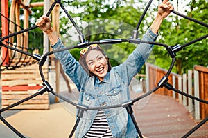 Woman in an adventure rope park at children playground