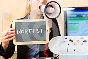 Woman advertising a hearing test photo