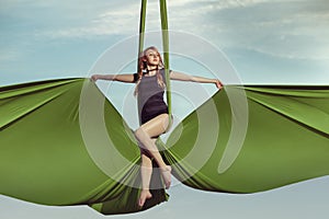 Woman aerial acrobat performs.