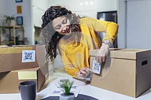 Woman affixing QR codes onto storage boxes. Concept organization, efficiency, or technology in storage management photo