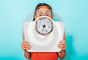 Woman is afraid of weight measurement with scale