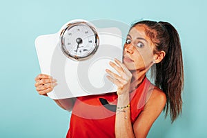 Woman is afraid of weight measurement with scale