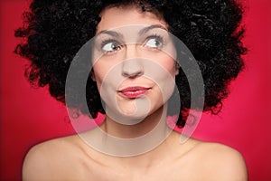 Woman with afro wig looking to the side