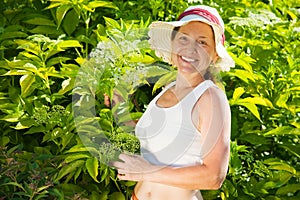 Woman against cornus in garden
