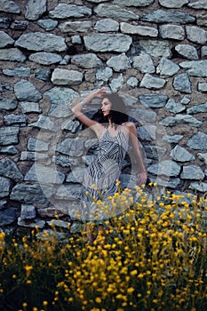 Woman Against Old Stone Wall