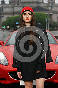 woman against red sport car